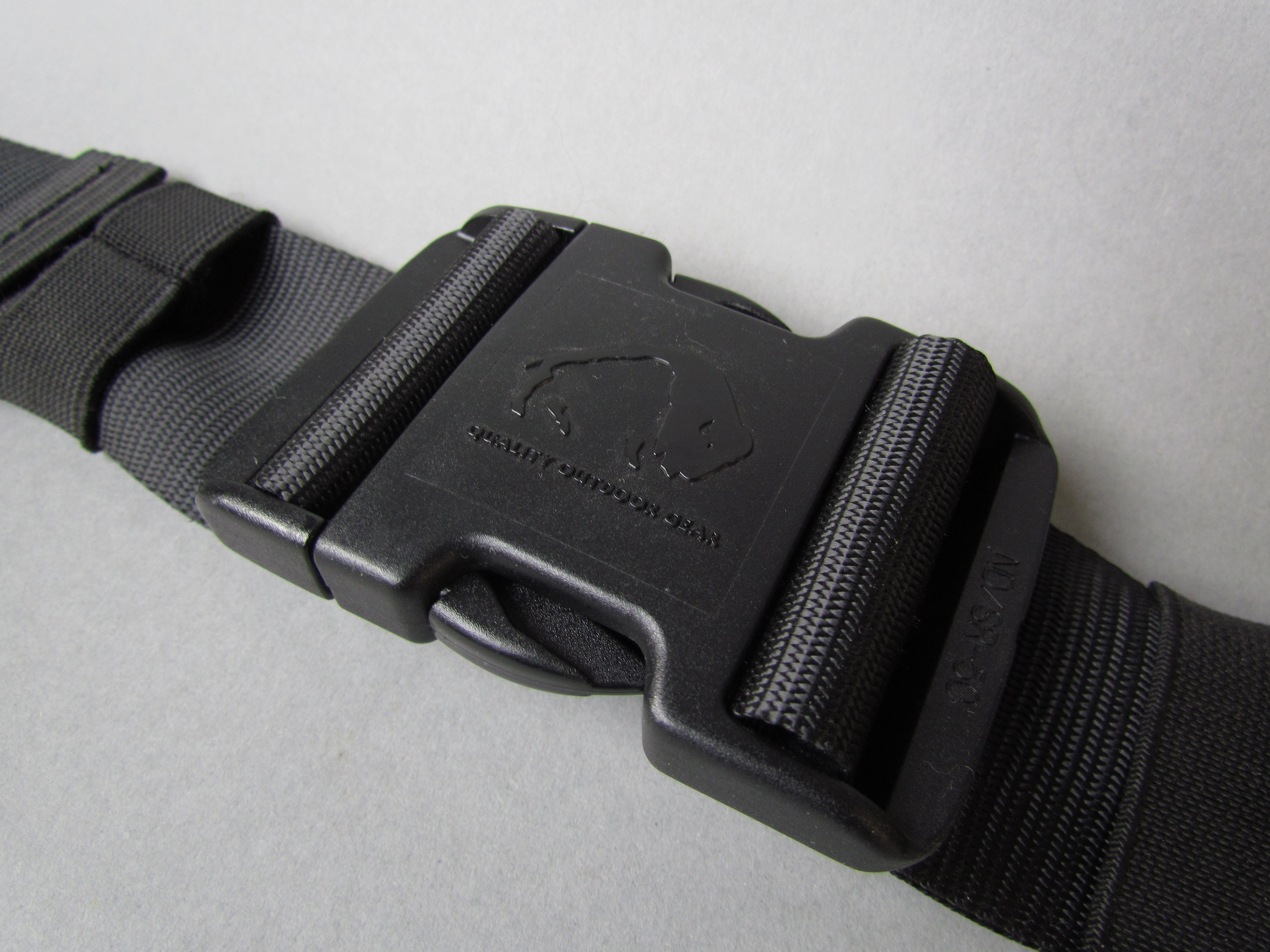 Side-release buckle attached to black webbing. Third-party reference photograph, not a JKPD product. Polymer grade and load performance are not established.