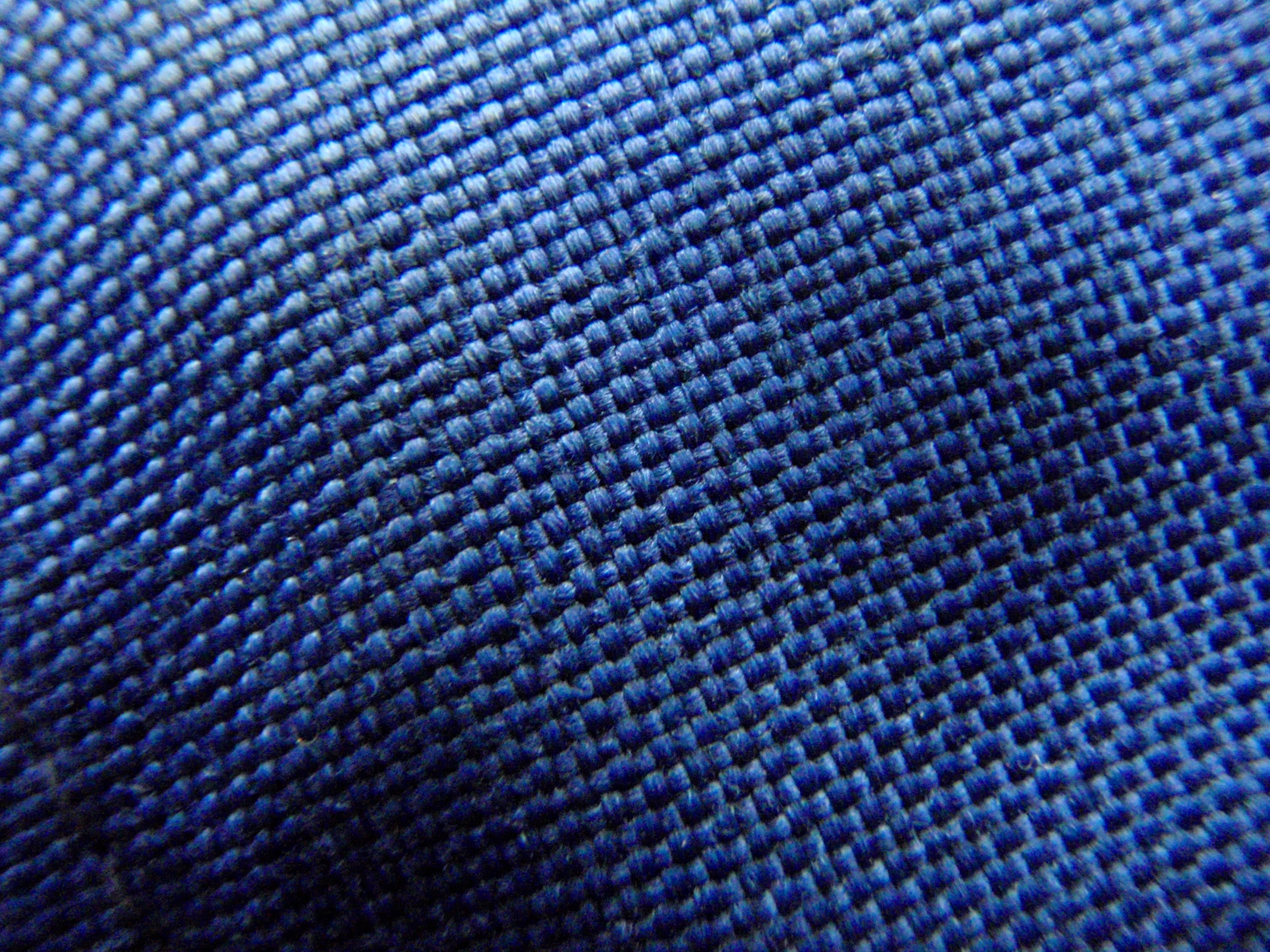 Photograph of blue interlaced fabric texture. Identified as CORDURA by the source; family, denier and fabric article are not established.