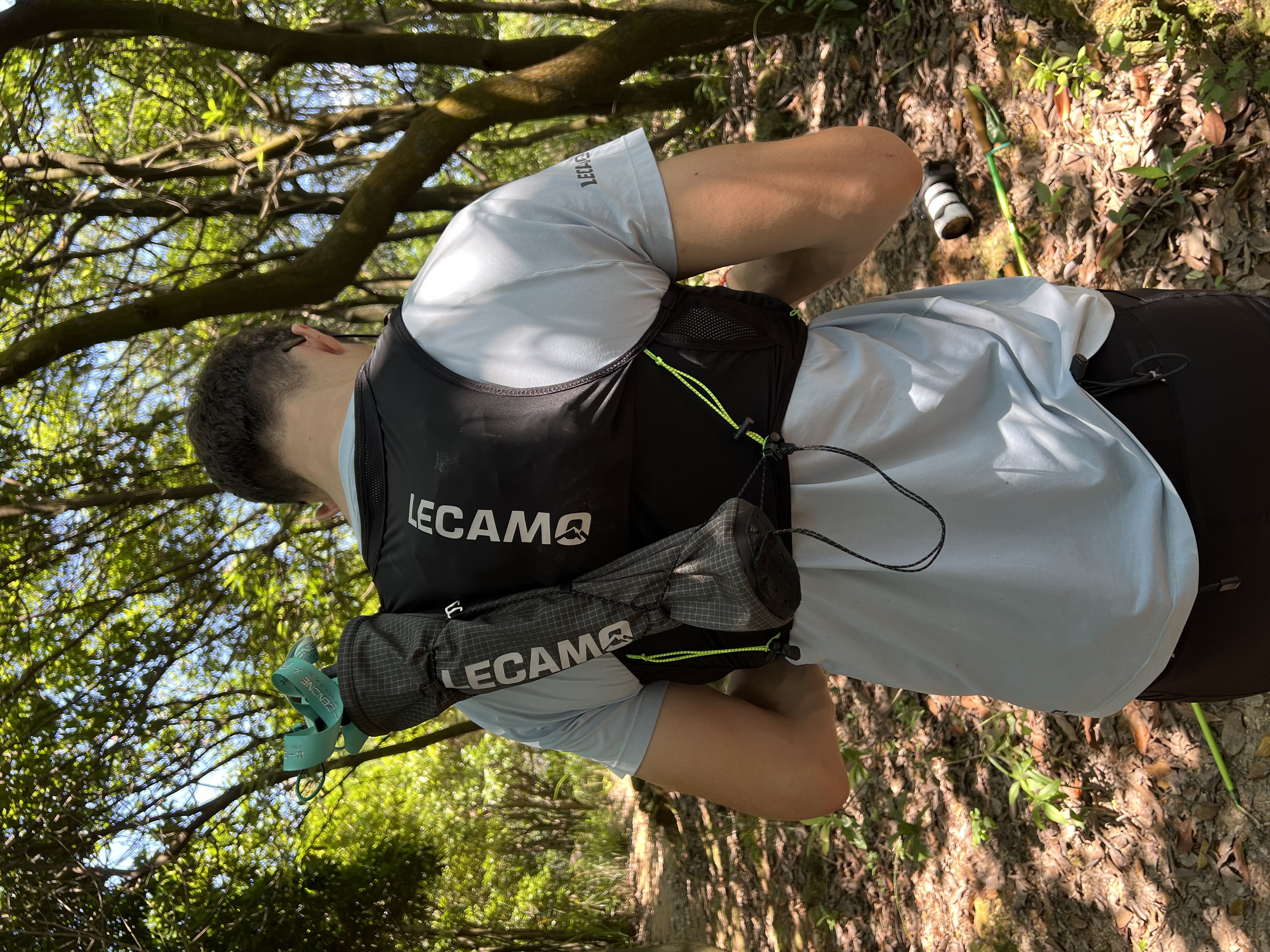Rear worn view in woodland, with the quiver angled along one side and pole handles above its opening