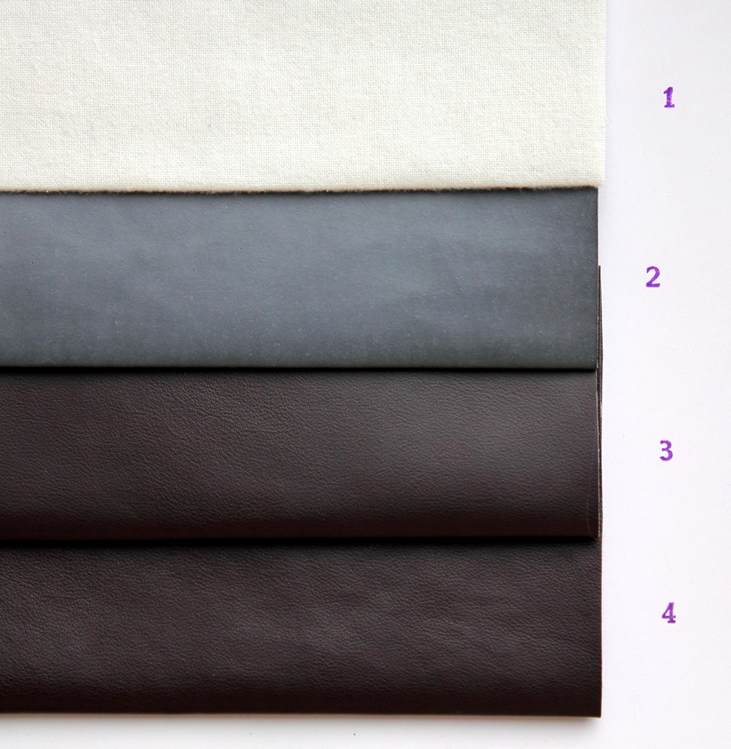 Real photograph of staged PU synthetic-leather samples. Source identifies cotton backing, wet processing, then coating and finishing stages. Not a scaled cross-section or a universal construction. Source revision includes white-balance correction; unmodified here.